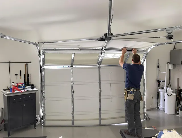 Warwick Garage Door Repair specialist performing precise section replacement on Warwick garage door